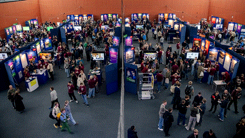 The students go around talking with fellow students and teachers.